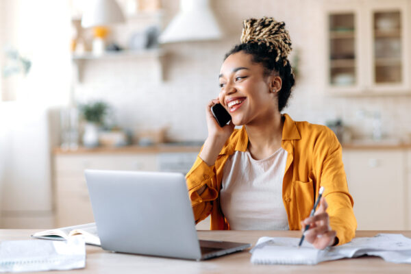 woman african american pretty happy online phone talk distance Happy successful busy young african american woman, broker, manager or freelancer working remotely, have pleasantly conversation with client or employee on the phone looking away smiling friendly