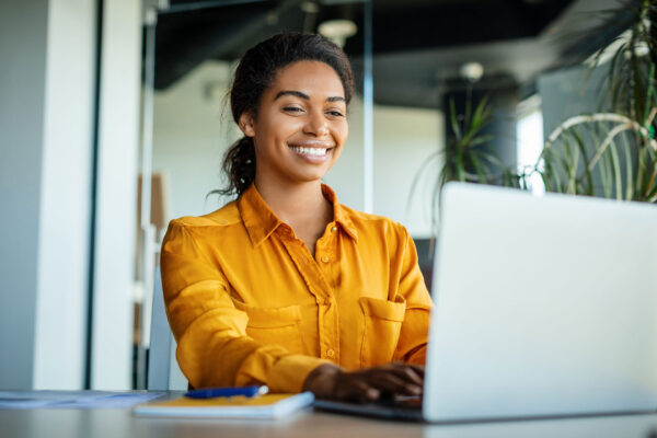 Happy-businesswoman-using-SAP-Business-One-while-sitting-at-workplace Happy-businesswoman-using-SAP-Business-One-while-sitting-at-workplace