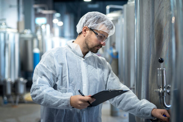 Middle-aged-concentrated-technologist-worker-controlling-production-in-pharmaceutical-or-chemical-industry.
