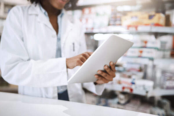Pharma-Pharmacist,-tablet-and-woman-for-healthcare,-medicine-and-digital-vaccine-prescription-in-health-store.-Employee,-technology-and-online-pharmacy-for-medical-service