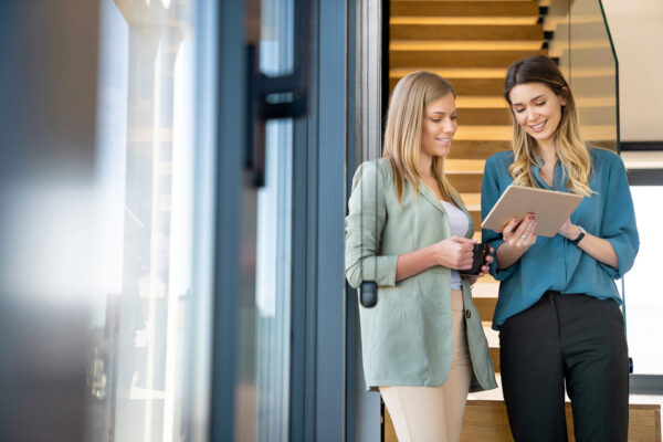 Two-blond-professional-business-women-working-in-corporate-office Two-blond-professional-business-women-working-in-corporate-office