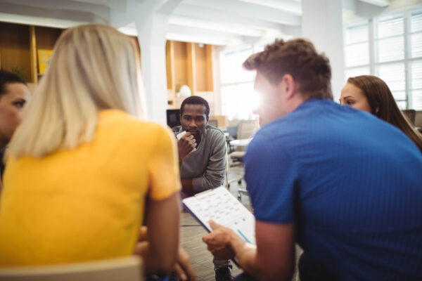 Business executives interacting with each other Business executives interacting with each other during meeting in office